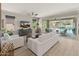 Bright living room with modern white furnishings and sliding glass doors to the outdoor patio at 13186 W Via Dona Rd, Peoria, AZ 85383