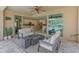 Outdoor living area featuring a fire pit, comfortable seating, and a seamless transition to the indoor kitchen at 13186 W Via Dona Rd, Peoria, AZ 85383