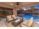 Outdoor living space with comfortable seating, fire pit, and view of the pool and spa at 13186 W Via Dona Rd, Peoria, AZ 85383