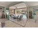 Indoor patio features a cozy seating area with a fire pit, overlooking a pool at 13186 W Via Dona Rd, Peoria, AZ 85383