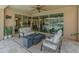 Inviting covered patio with comfortable seating and a modern fire pit, perfect for outdoor relaxation and entertaining at 13186 W Via Dona Rd, Peoria, AZ 85383