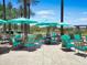 Outdoor patio seating area with tables, chairs, umbrellas, and views of lush greenery and palm trees at 13186 W Via Dona Rd, Peoria, AZ 85383