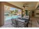 A covered patio with stylish outdoor seating overlooks a pool and spa at 13186 W Via Dona Rd, Peoria, AZ 85383