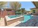 Beautiful backyard featuring a pool, spa, and well-maintained landscaping, perfect for outdoor enjoyment at 13186 W Via Dona Rd, Peoria, AZ 85383