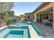 Stunning pool and spa with cascading waterfall feature, creating a tranquil and luxurious outdoor retreat at 13186 W Via Dona Rd, Peoria, AZ 85383