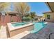 An inviting pool and spa are surrounded by a travertine tile patio at 13186 W Via Dona Rd, Peoria, AZ 85383