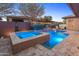 Beautiful pool and spa surrounded by travertine tile, lush landscaping, and landscape lighting for a private oasis at 13186 W Via Dona Rd, Peoria, AZ 85383