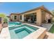 An inviting pool and spa are surrounded by a travertine tile patio at 13186 W Via Dona Rd, Peoria, AZ 85383