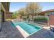 Inviting backyard pool and spa, surrounded by lush landscaping and mature trees, creating a private oasis at 13186 W Via Dona Rd, Peoria, AZ 85383