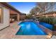 Stunning pool with travertine deck, water features, a raised spa, and lush landscaping for a relaxing outdoor oasis at 13186 W Via Dona Rd, Peoria, AZ 85383