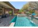 Scenic backyard with a pool, spa, and elegant landscaping, creating a serene and inviting outdoor space at 13186 W Via Dona Rd, Peoria, AZ 85383