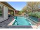 Sparkling pool with travertine deck and a gentle waterfall, perfect for enjoying sunny days and outdoor living at 13186 W Via Dona Rd, Peoria, AZ 85383