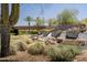 Scenic waterfall feature with lush landscaping and the Trilogy sign, offering a tranquil outdoor experience at 13186 W Via Dona Rd, Peoria, AZ 85383