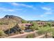 Scenic aerial view of a home with lush desert landscaping and mountain backdrop at 13945 E Gail Rd, Scottsdale, AZ 85259