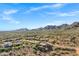 Scenic aerial view of desert community homes with backyard pools surrounded by mountain views at 13945 E Gail Rd, Scottsdale, AZ 85259