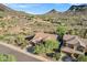 Homes nestled into the desert landscape, showing three-car garages and tile roofs at 13945 E Gail Rd, Scottsdale, AZ 85259