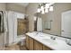 Bathroom with double sinks, shower/tub combo, and a large mirror at 13945 E Gail Rd, Scottsdale, AZ 85259