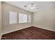 Bedroom with hardwood floors, neutral walls, ceiling fan, and natural light at 13945 E Gail Rd, Scottsdale, AZ 85259