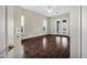 Bedroom with wood floors, neutral walls, and glass doors to balcony at 13945 E Gail Rd, Scottsdale, AZ 85259