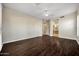 Large primary bedroom with dark wood floors, ceiling fan, and ensuite access at 13945 E Gail Rd, Scottsdale, AZ 85259
