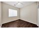 Cozy bedroom with a ceiling fan, hardwood floors, and a window at 13945 E Gail Rd, Scottsdale, AZ 85259