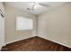 Bedroom with a ceiling fan, hardwood floors, and a window at 13945 E Gail Rd, Scottsdale, AZ 85259