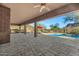 Spacious covered patio with fan featuring mountain views, lounge chairs, and pool at 13945 E Gail Rd, Scottsdale, AZ 85259