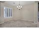 Neutral dining area with tile flooring, a chandelier, and large windows with bright natural light at 13945 E Gail Rd, Scottsdale, AZ 85259