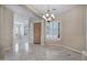 Elegant dining room with tile floors, a decorative chandelier, and shuttered windows for bright, natural light at 13945 E Gail Rd, Scottsdale, AZ 85259