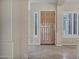 Light-filled foyer showcasing tile flooring, neutral walls, and shuttered windows for natural light control at 13945 E Gail Rd, Scottsdale, AZ 85259