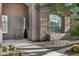 Inviting front entrance with a decorative door, desert landscaping, and a smooth walkway to the home at 13945 E Gail Rd, Scottsdale, AZ 85259