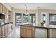 Kitchen featuring an island, stainless appliances, and large windows with views at 13945 E Gail Rd, Scottsdale, AZ 85259