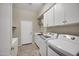Well-lit laundry room featuring tile floors and modern washer and dryer at 13945 E Gail Rd, Scottsdale, AZ 85259