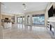 Expansive living area with tile flooring, fireplace, and views of the backyard and surrounding scenery at 13945 E Gail Rd, Scottsdale, AZ 85259