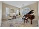 Inviting living room with piano, plantation shutters, and tile flooring at 13945 E Gail Rd, Scottsdale, AZ 85259