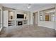 Bright living room with a fireplace, built-in shelving, tile flooring, and neutral color walls at 13945 E Gail Rd, Scottsdale, AZ 85259