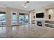 Bright living room with fireplace and pool view through large windows at 13945 E Gail Rd, Scottsdale, AZ 85259