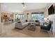 Open-concept living room boasts fireplace, comfortable seating, and access to outdoor patio with mountain views at 13945 E Gail Rd, Scottsdale, AZ 85259