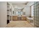 Bright bathroom with dual vanities, a soaking tub, and a glass block shower at 13945 E Gail Rd, Scottsdale, AZ 85259