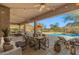 Expansive covered patio featuring an outdoor kitchen, dining area, comfortable seating, and mountain views at 13945 E Gail Rd, Scottsdale, AZ 85259