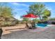 Backyard pool featuring lounge chairs and a red umbrella with mountain views at 13945 E Gail Rd, Scottsdale, AZ 85259