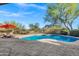Inviting backyard pool with lounge chairs, mountain views and an umbrella at 13945 E Gail Rd, Scottsdale, AZ 85259