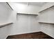 Spacious walk-in closet with custom shelving and a beautiful wood floor at 13945 E Gail Rd, Scottsdale, AZ 85259