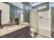 Stylish bathroom featuring a modern vanity with a mirror and a shower-tub combination with decorative wallpaper at 1415 W J Waltz Way, Apache Junction, AZ 85120