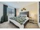 Cozy bedroom features a comfortable bed with decorative floral accents and a wooden headboard at 1415 W J Waltz Way, Apache Junction, AZ 85120