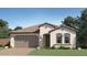 Charming single-story home featuring a tile roof, two-car garage, and professionally landscaped front yard at 1415 W J Waltz Way, Apache Junction, AZ 85120