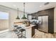 Modern kitchen featuring stainless steel appliances, a center island with seating, and stylish pendant lighting at 1415 W J Waltz Way, Apache Junction, AZ 85120