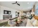 Spacious living room featuring modern furnishings, a decorative rug, and an open layout to the dining area at 1415 W J Waltz Way, Apache Junction, AZ 85120