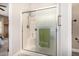 Bright shower with a glass enclosure, shower bench, and green accent towel offers a rejuvenating spa-like experience at 14819 W Lupine Ln, Surprise, AZ 85374