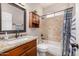 Bathroom featuring a shower-tub combo with stylish tile and vanity with a granite countertop at 14819 W Lupine Ln, Surprise, AZ 85374
